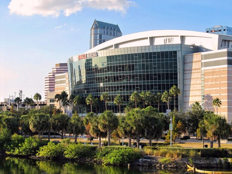 Benchmark International Arena (formerly Amalie Arena), a glass-fronted arena on the Tampa waterfront surrounded by palm trees