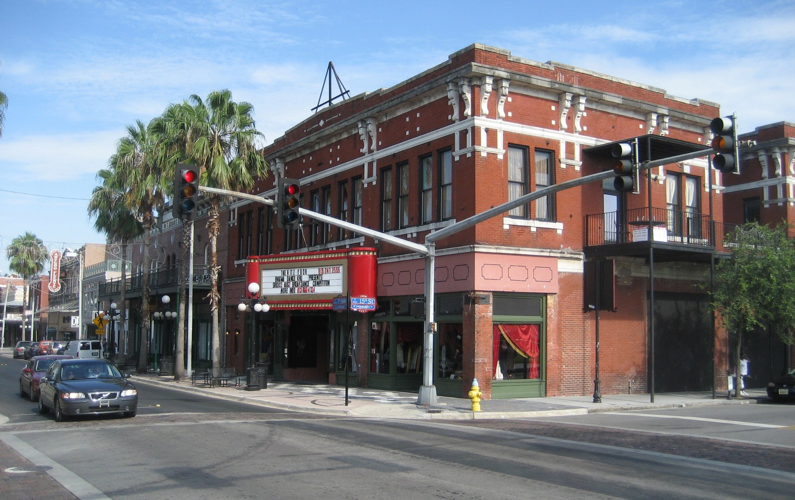 The historic red-brick exterior of The Ritz Ybor theater building at the corner of 7th Avenue and 15th Street in Ybor City, Tampa, with its marquee reading THE RITZ YBOR.