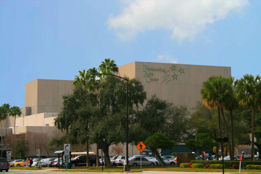 Exterior of the Straz Center performing arts complex in Tampa behind palm trees